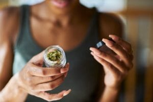 | Durango Rec Room woman holding jar of cannabis flower to the camera